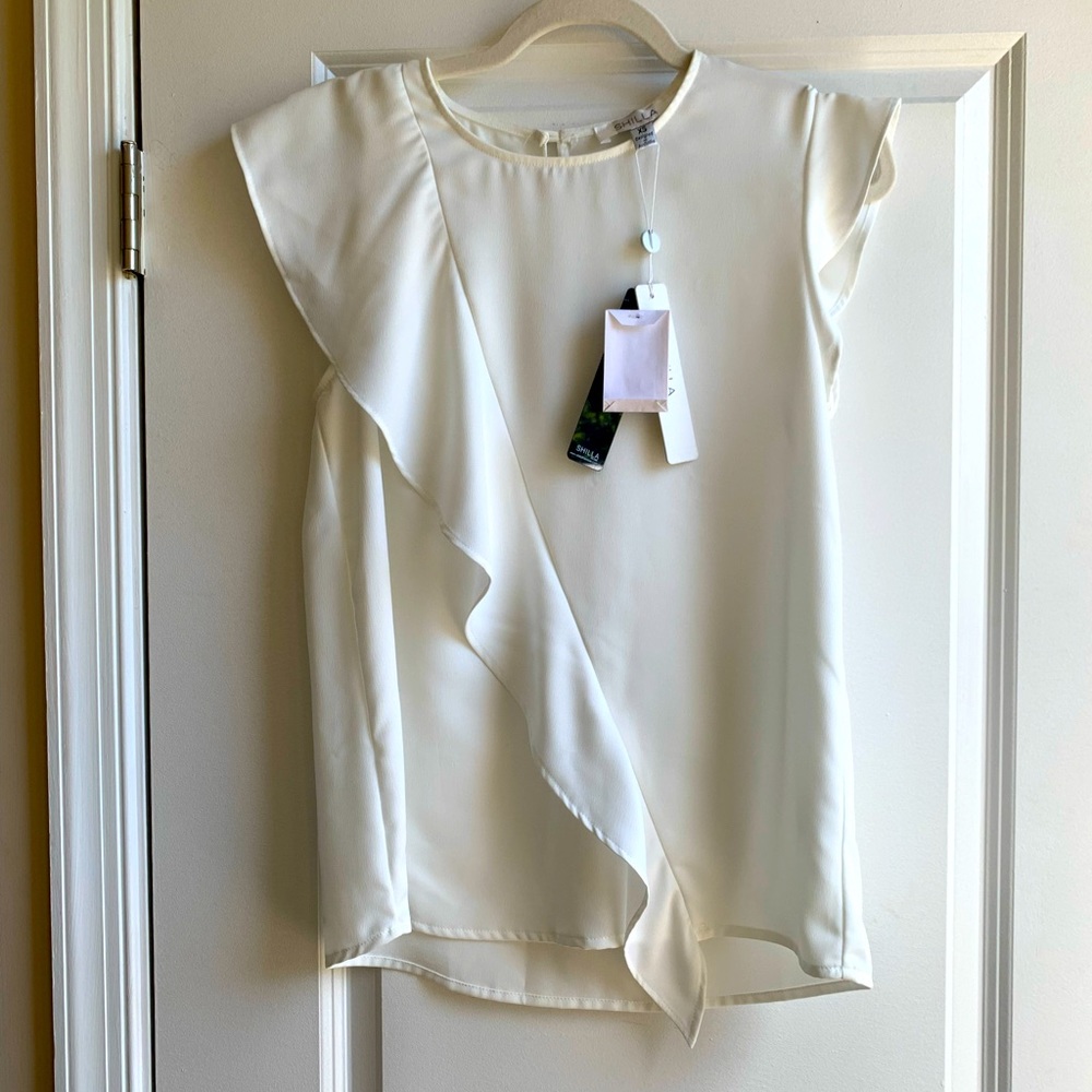 White ruffle blouse